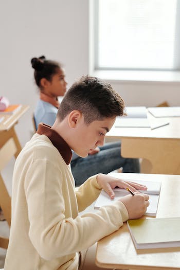 boy reading at school desk