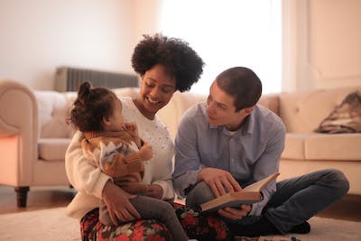 couple reading to young child